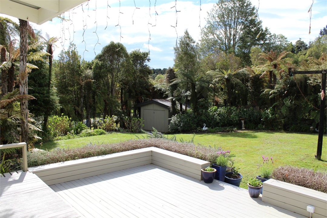 Deck off kitchen now has wooden table,chairs & umb