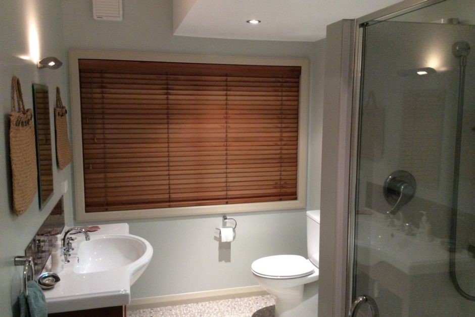 Blue bathroom: large shower, toilet & vanity