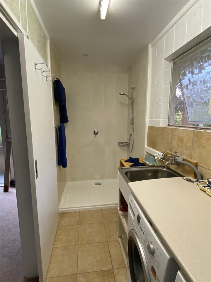 Downstairs laundry, washing machine, dryer and sho