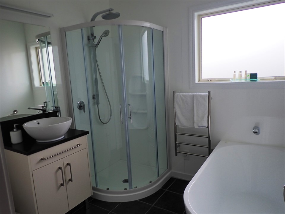 The main bathroom has a deep bath and separate sho