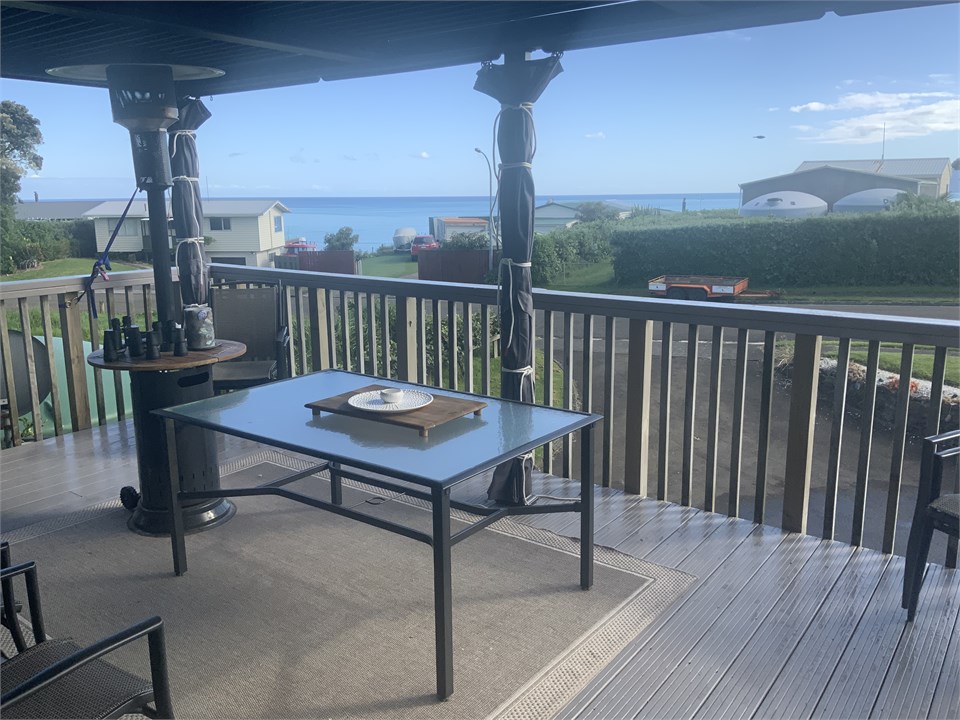 Gazebo over outdoor dining area including sea view