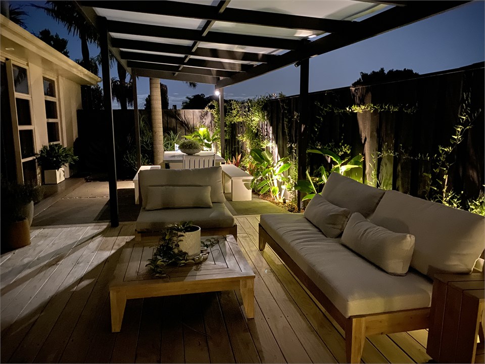 One of the outdoor lounge & dining areas at night