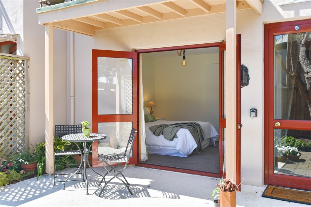 Outdoor seating area and Bedroom 2 through doors
