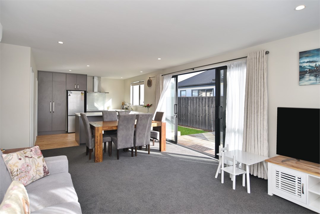 Living room with sitting areas and a TV