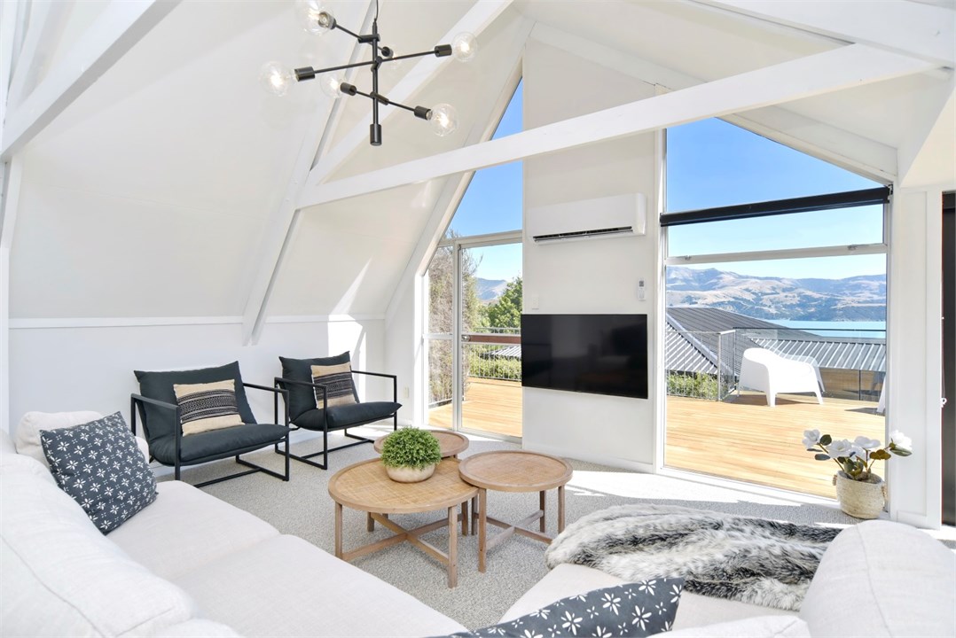 Living room has a TV and seating areas
