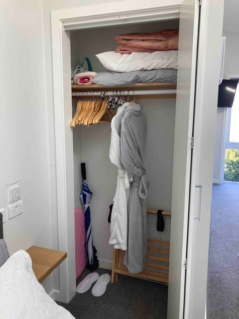 Wardrobe with dressing gowns, hot water bottles, e