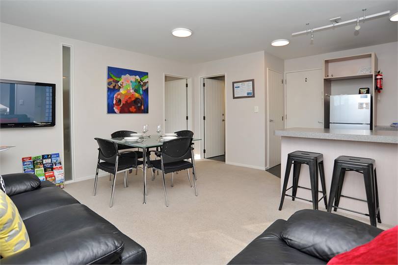 The living area with mounted flat screen TV and di