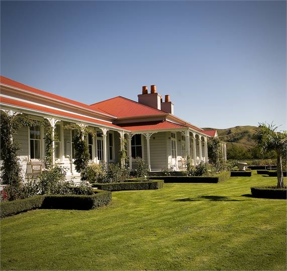 Wrap-around verandahs with delightful flower garde