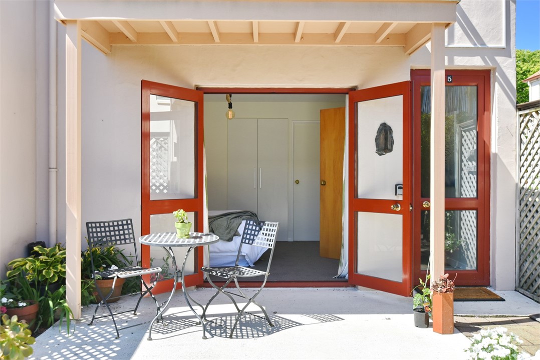 Outdoor seating area and Bedroom 2 through doors