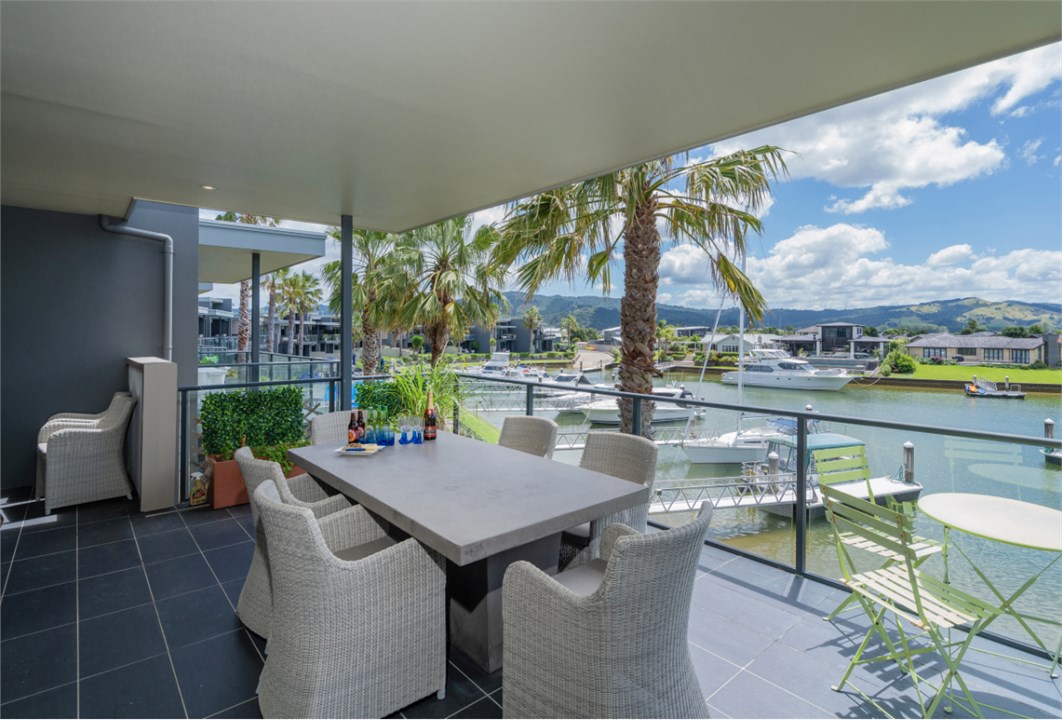 Outdoor area on balcony overlooking pool and water