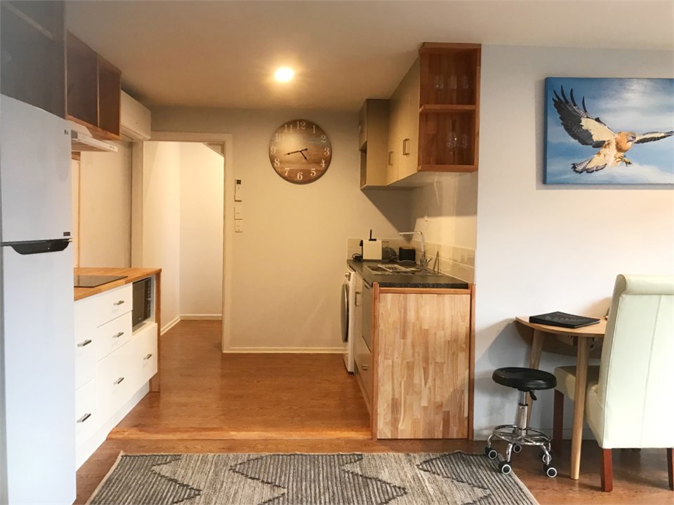 Fully equipped Galley kitchen leading to hallway