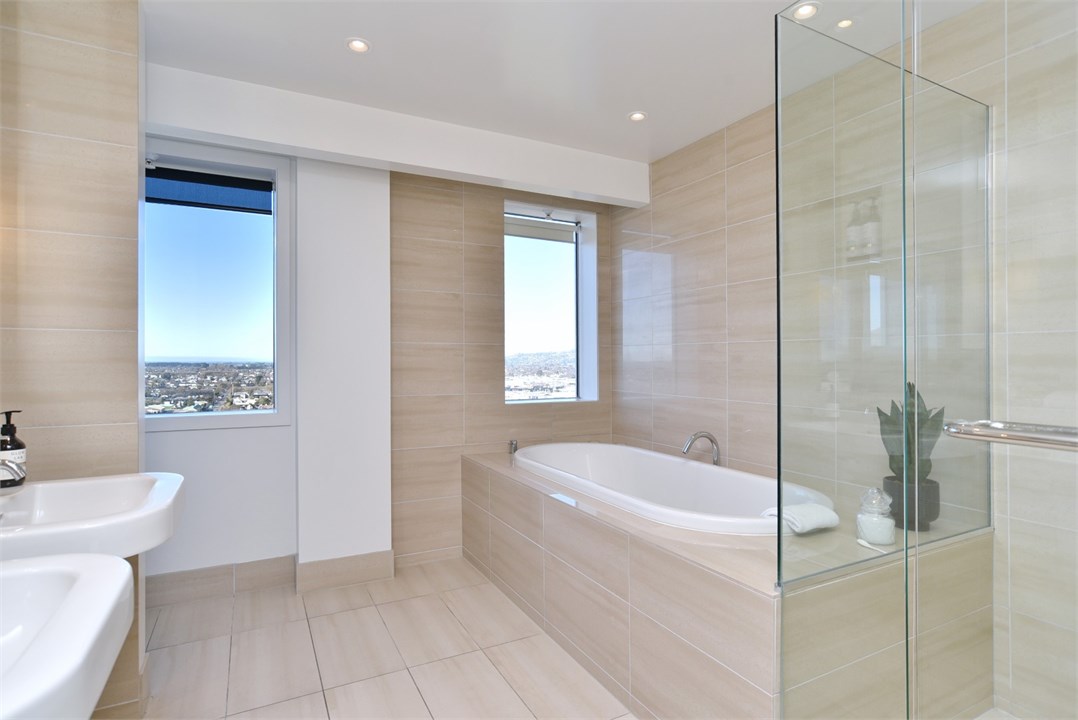 Bathroom 1 has a shower, bathtub and a toilet