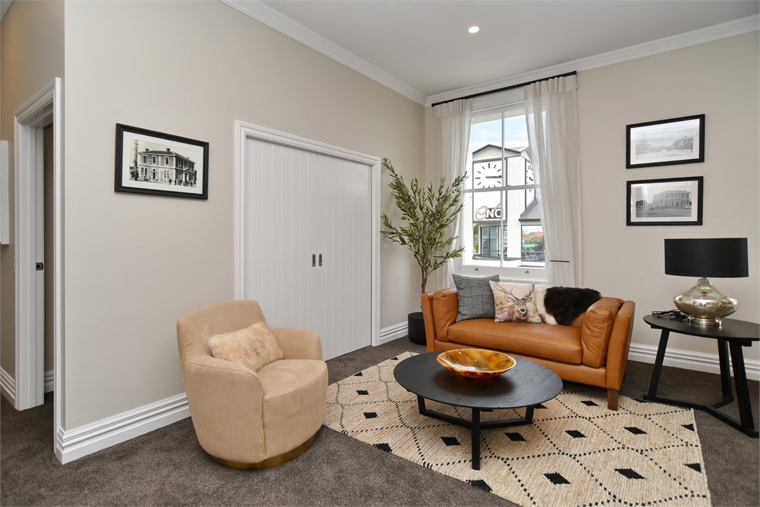 Living room has seating areas and a TV