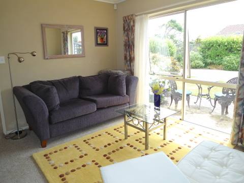 Sunny living room doors on to patio