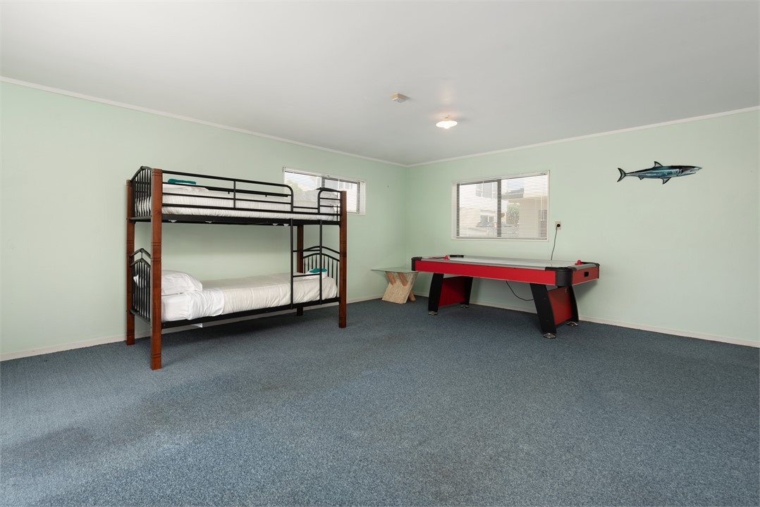Bedroom three with bunk beds and air hockey table