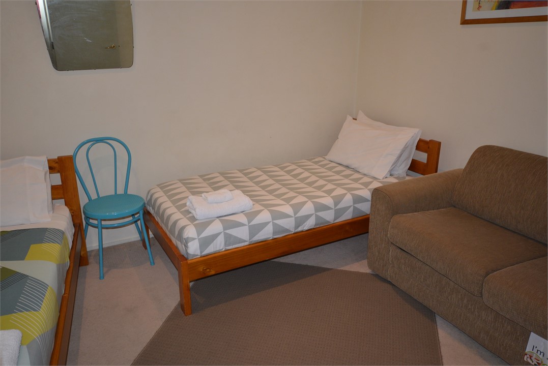 Family bedroom with 2 single beds, and sofa-bed