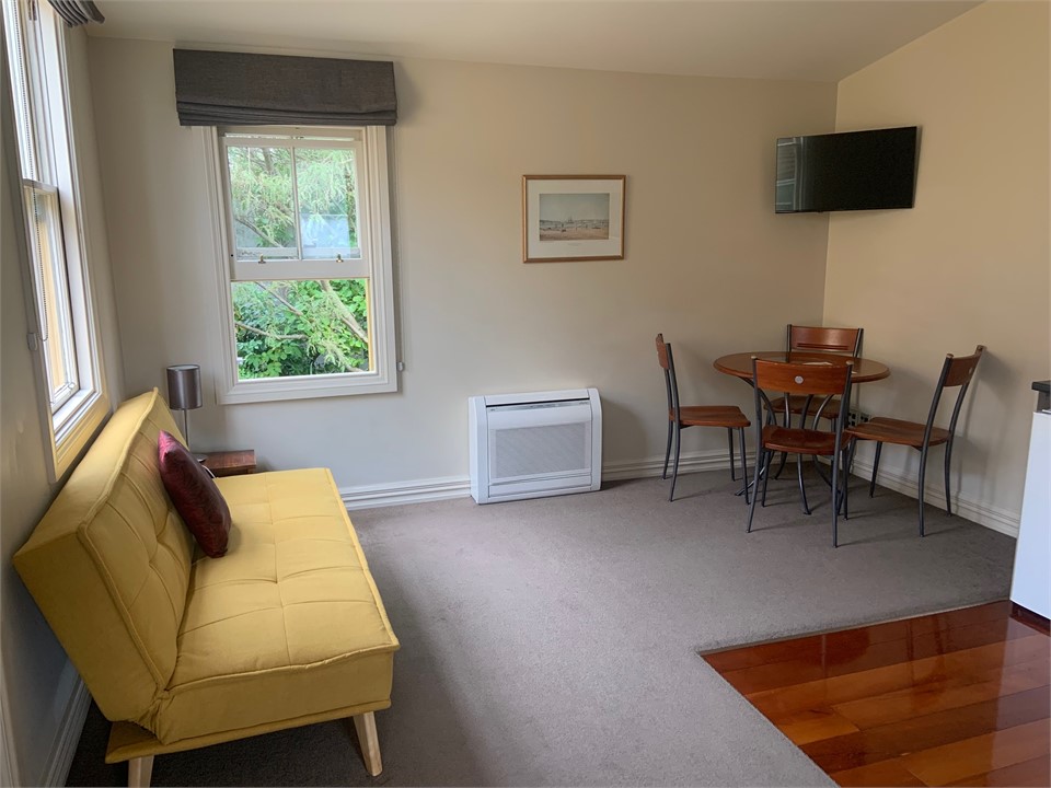 Sunny lounge with opening windows and aircon