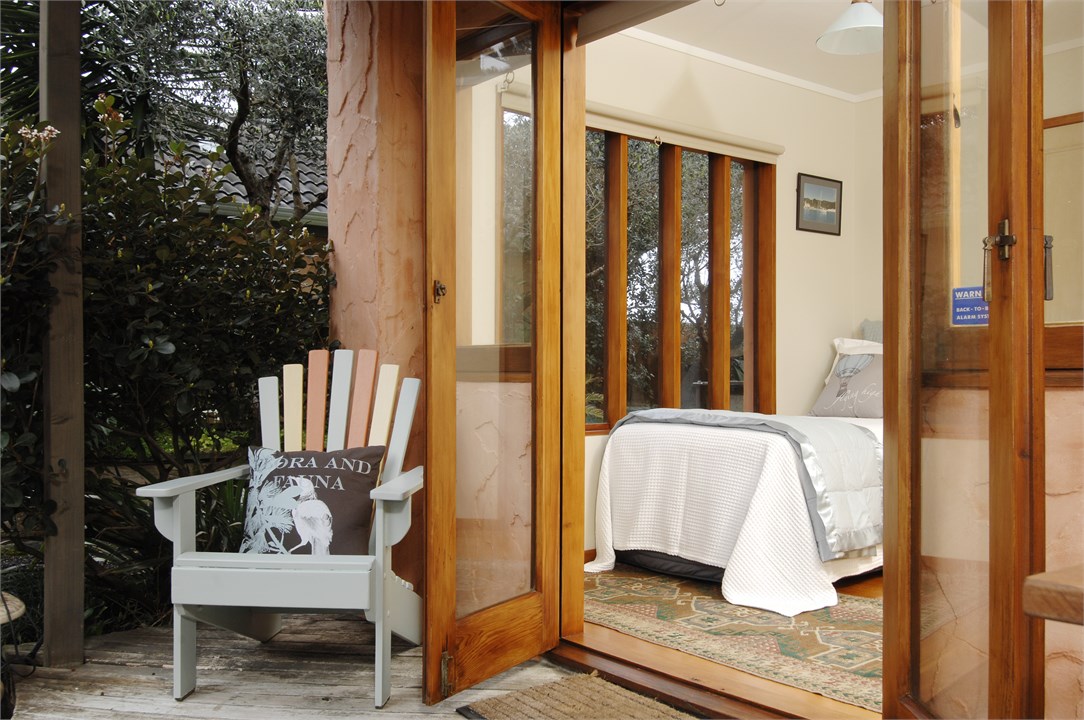 French doors open from bedroom to undercover deck 