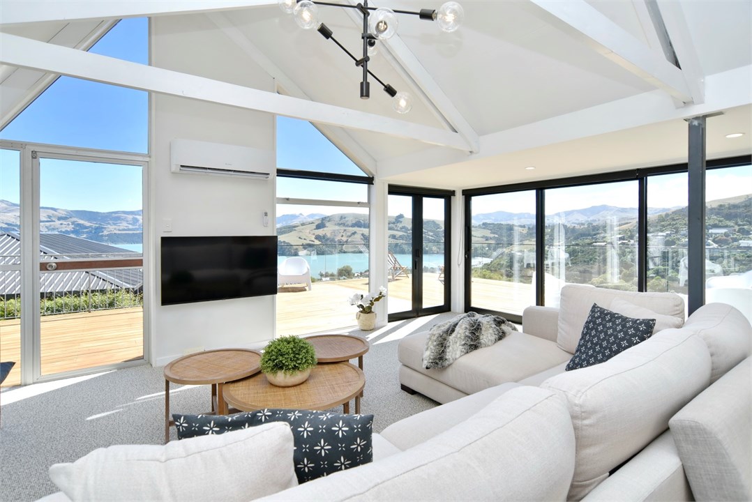 Living room has a TV and seating areas