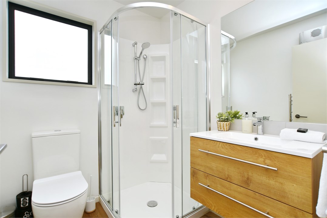 Bathroom 1 has a shower and a toilet