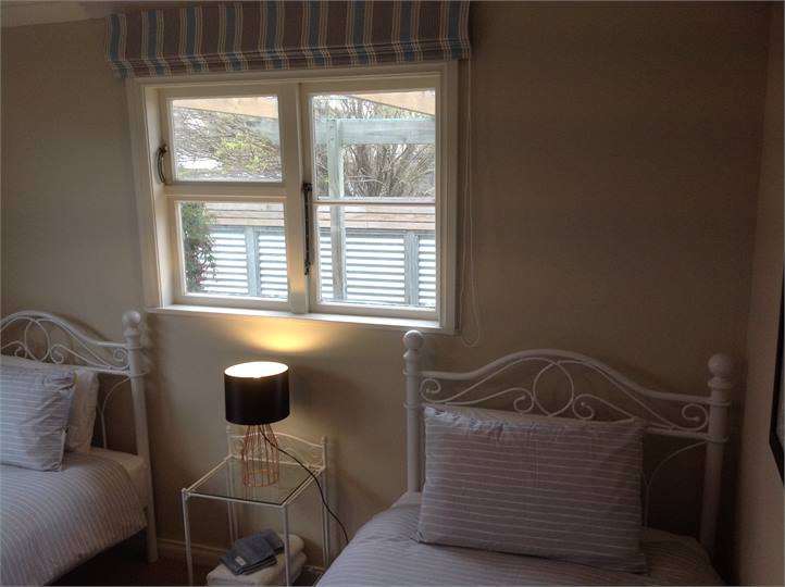 Bedroom 3: Two King Single Beds.