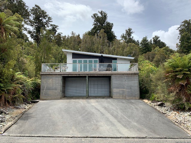 Front of House- wide drive to fit three cars acros