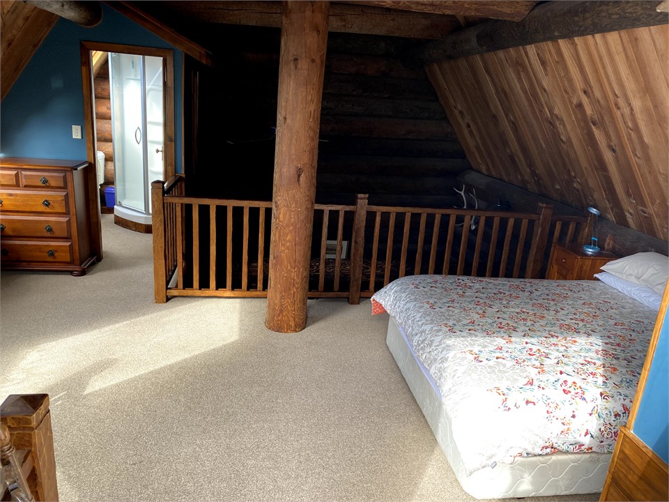 Main bedroom upstairs in log cabin with ensuite