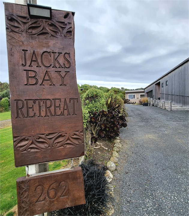 Signage at entrance, driveway to parking space at