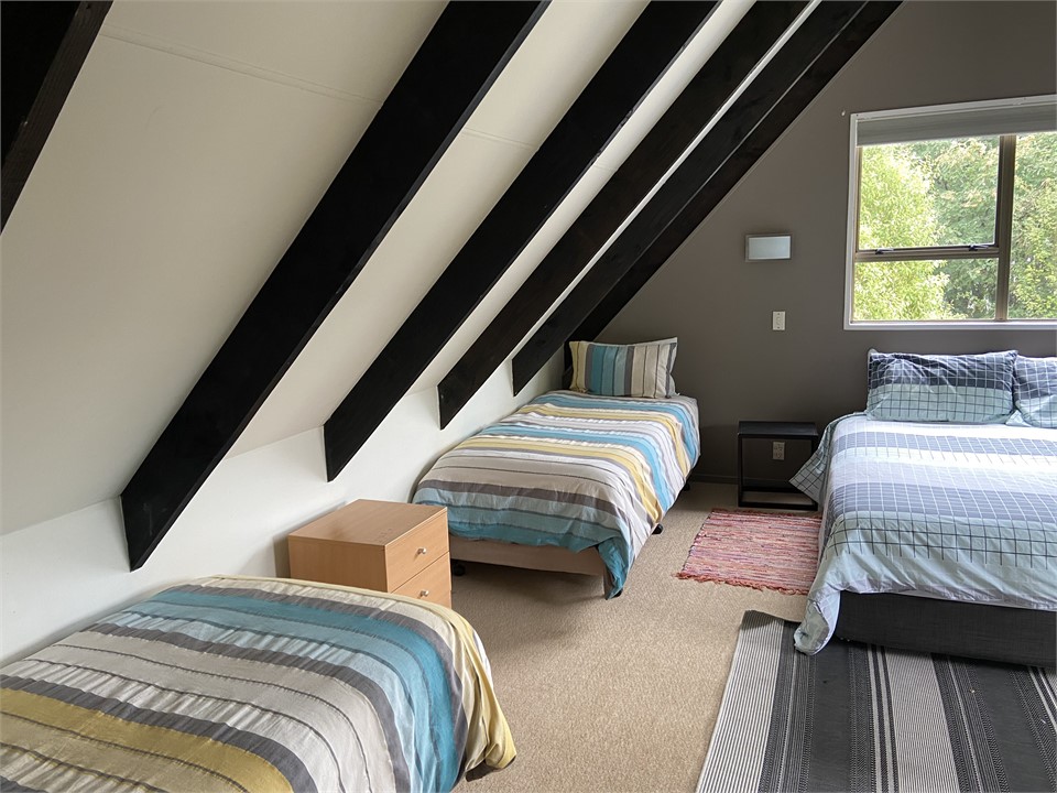 Upstairs bedroom. Queen bed with 2 single beds