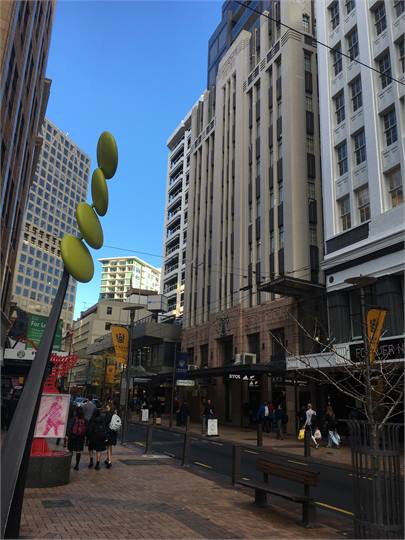 Apartment building (light brown building)