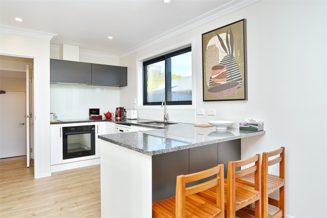 Full kitchen with a sitting area at the bench