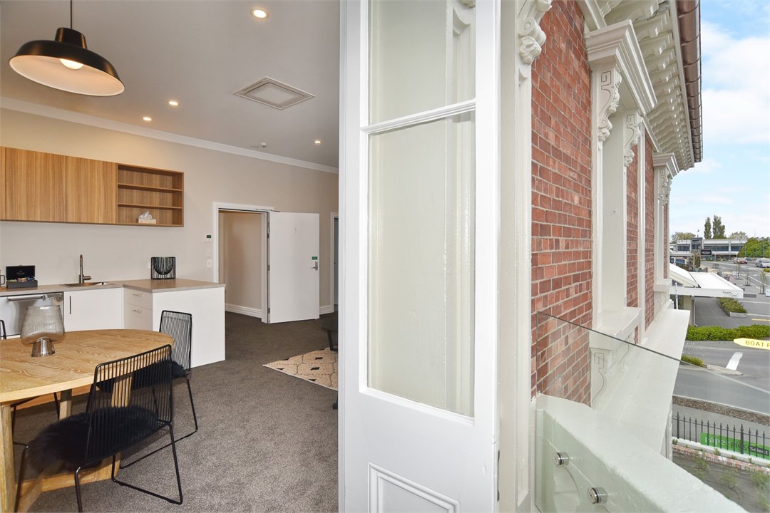 Living room has seating areas and a small balcony