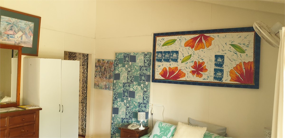 bed and wardrobe area, bathroom is beyond