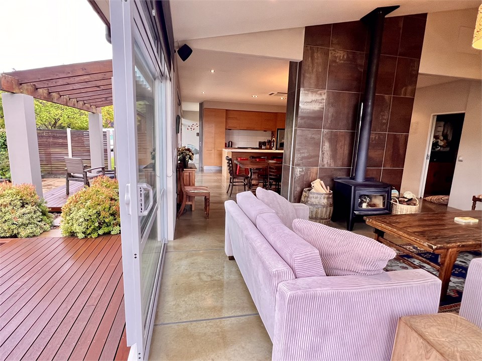 Living room has a TV, seating areas and a fireplac