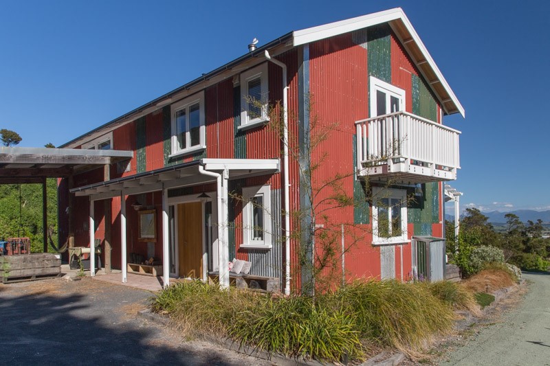The entry porch with the hay barn in the backgroun