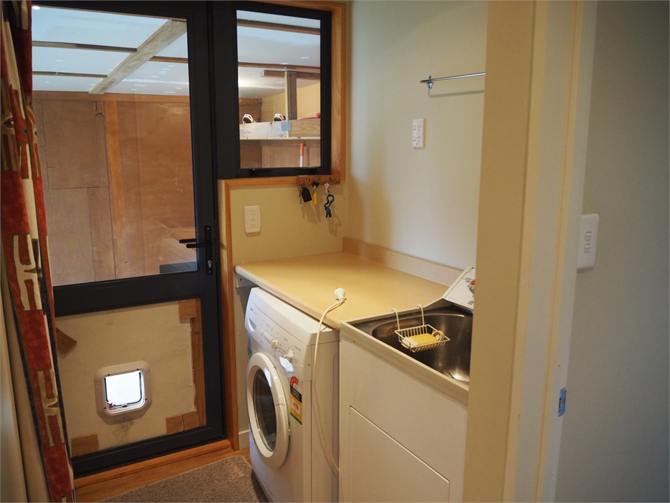 Laundry and back door entrance from carport