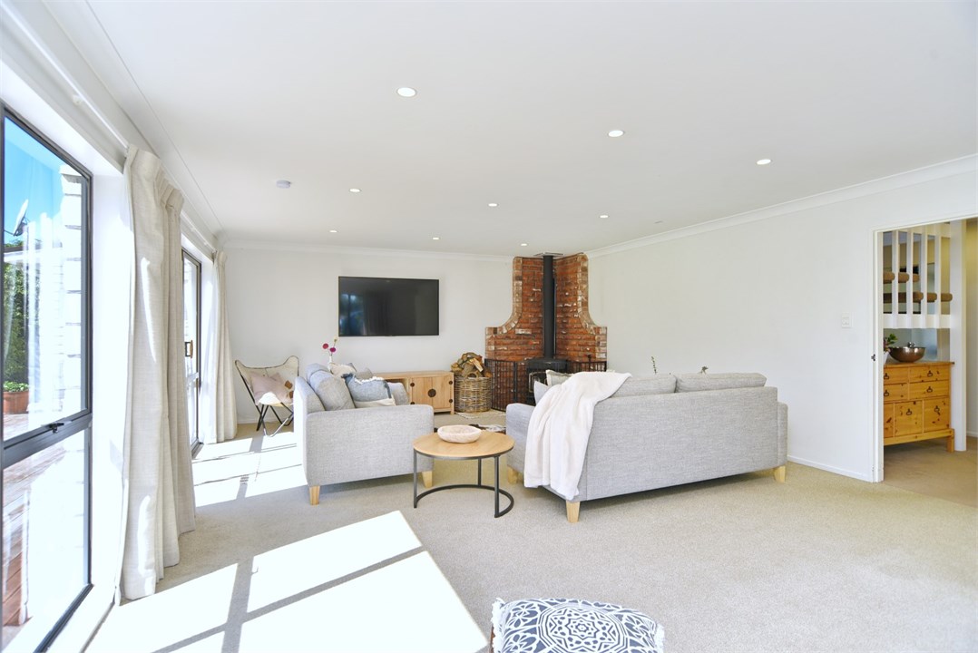 Living room has a TV seating areas and a fireplace