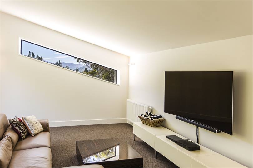 The media room with curved Smart TV, SKY and DVDs