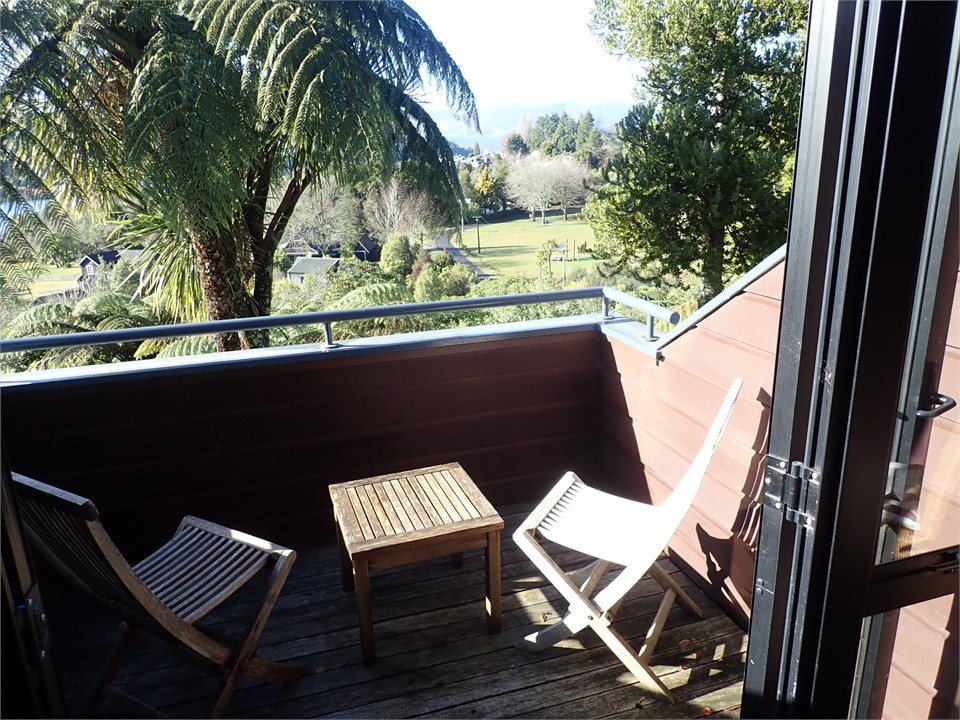 Views from balcony over bush and park to lake.