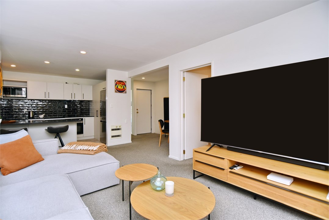 Living room has a TV and seating areas