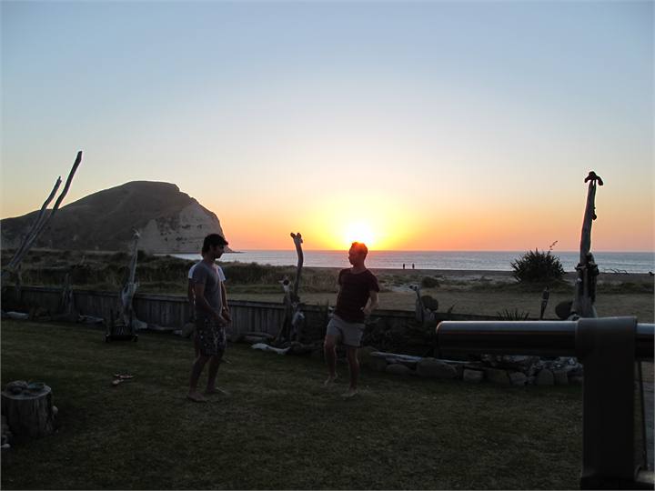Boys playing ball at sunset