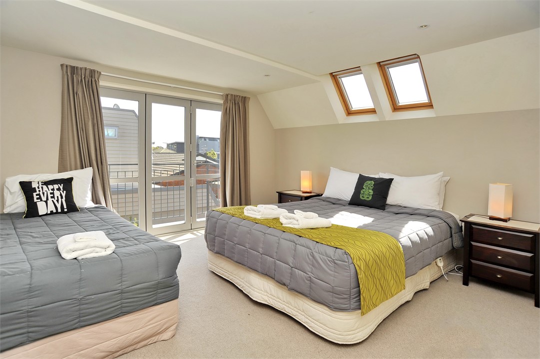 Bedroom 1 with a queen and single bed and ensuite 