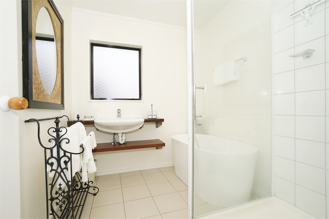 Bathroom has a shower, bathtub and a toilet