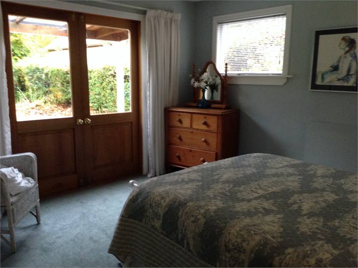 bedroom opening on to verandah and garden