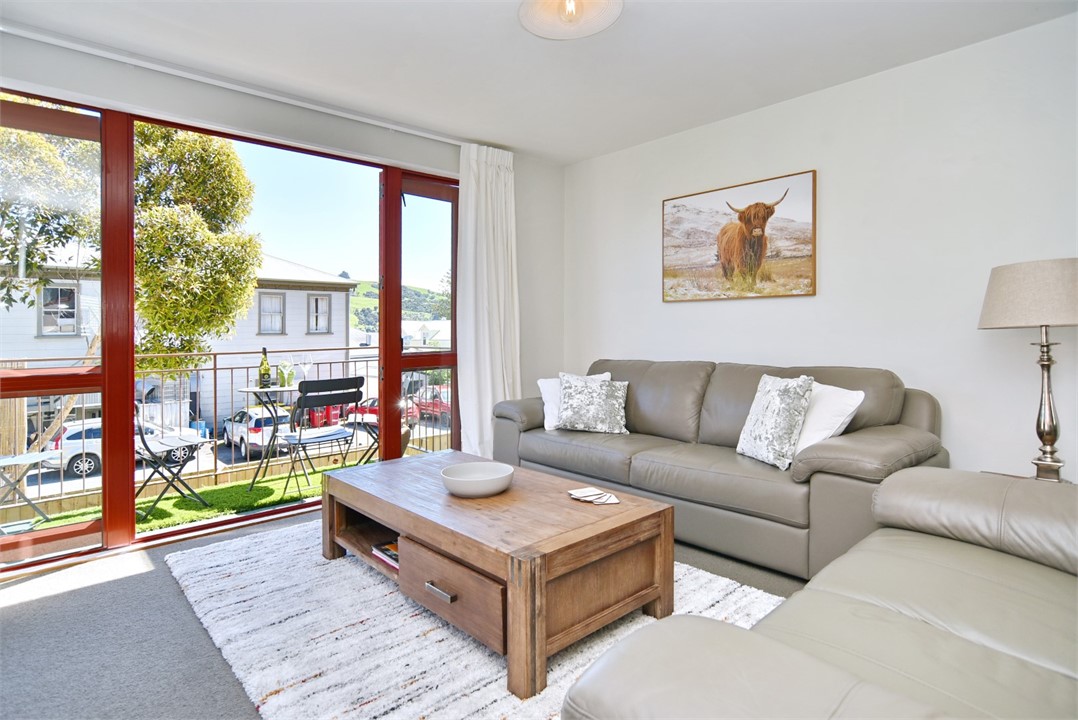Living room with outdoor seating on the balcony