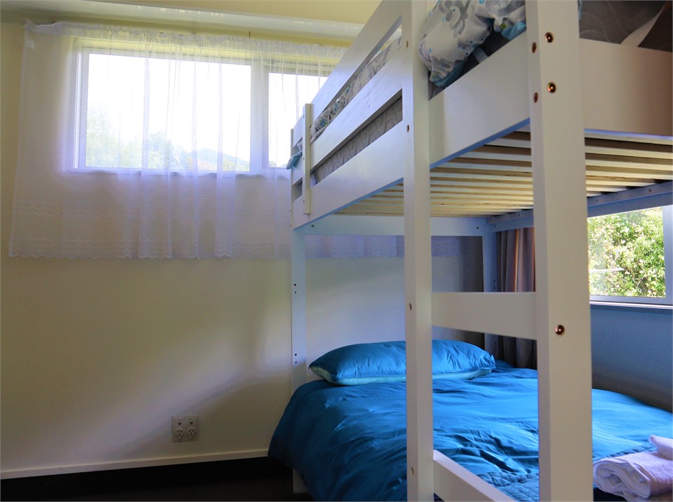 BDRM 3: Two single bunks with a view out to the ga