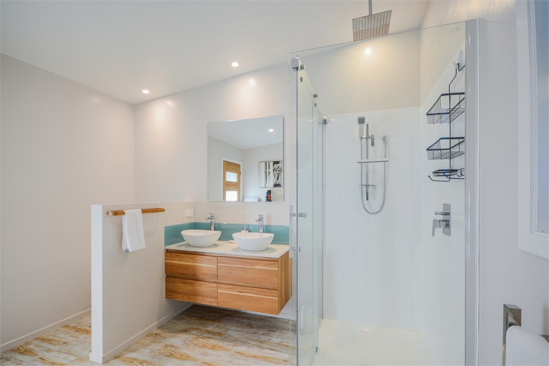 Bathroom has a shower, toilet and laundry area