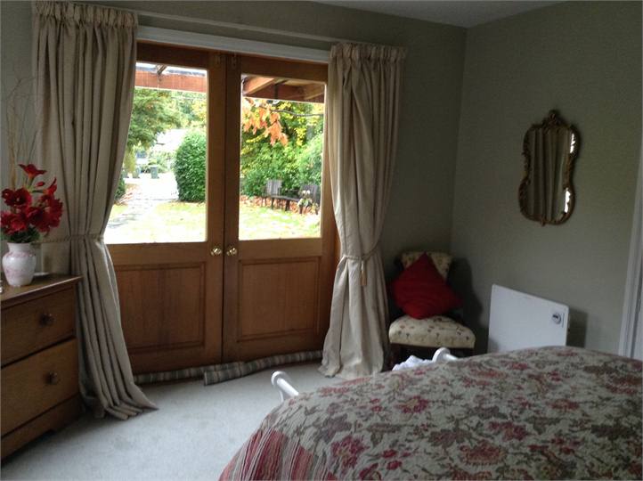 bedroom opening on to verandah and garden