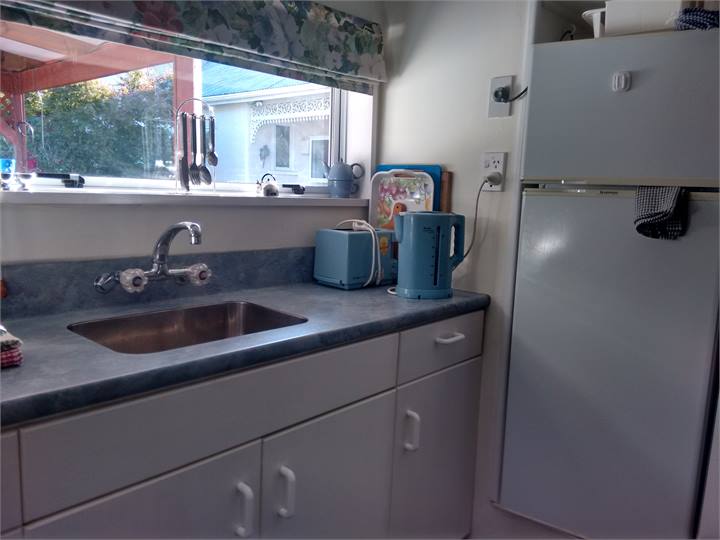 Kitchen full size fridge freezer covered courtyard