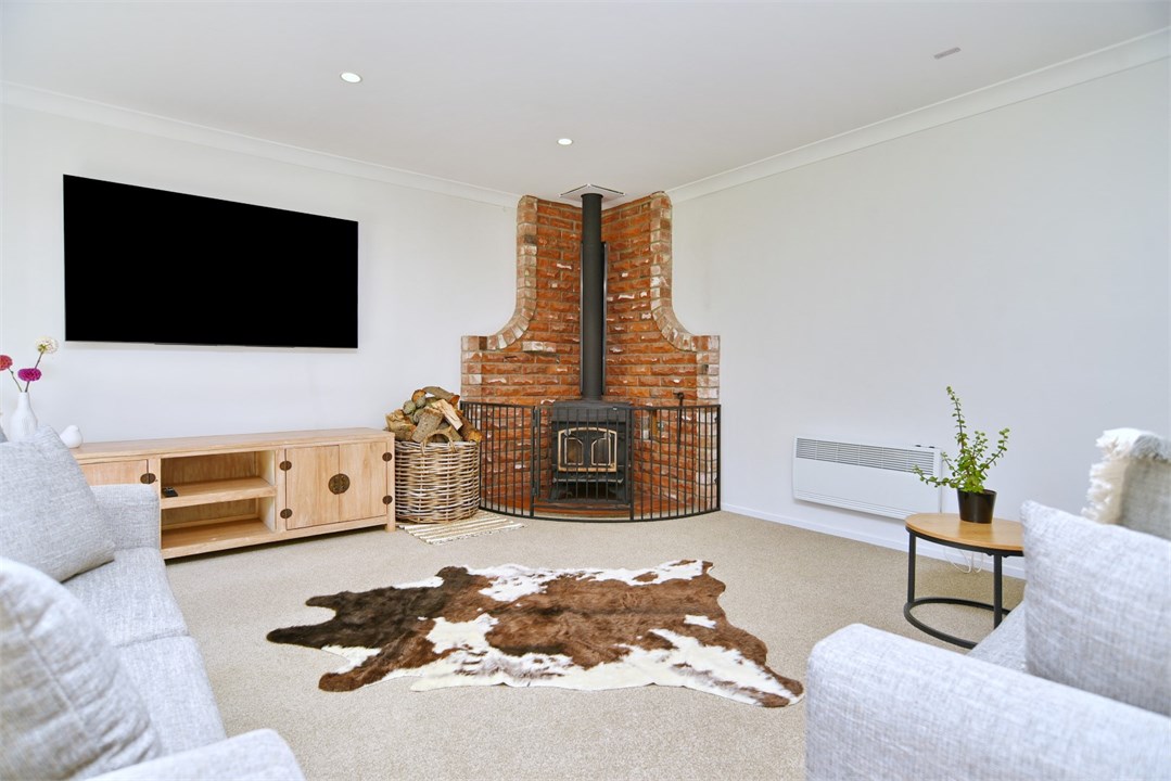 Living room has a TV seating areas and a fireplace